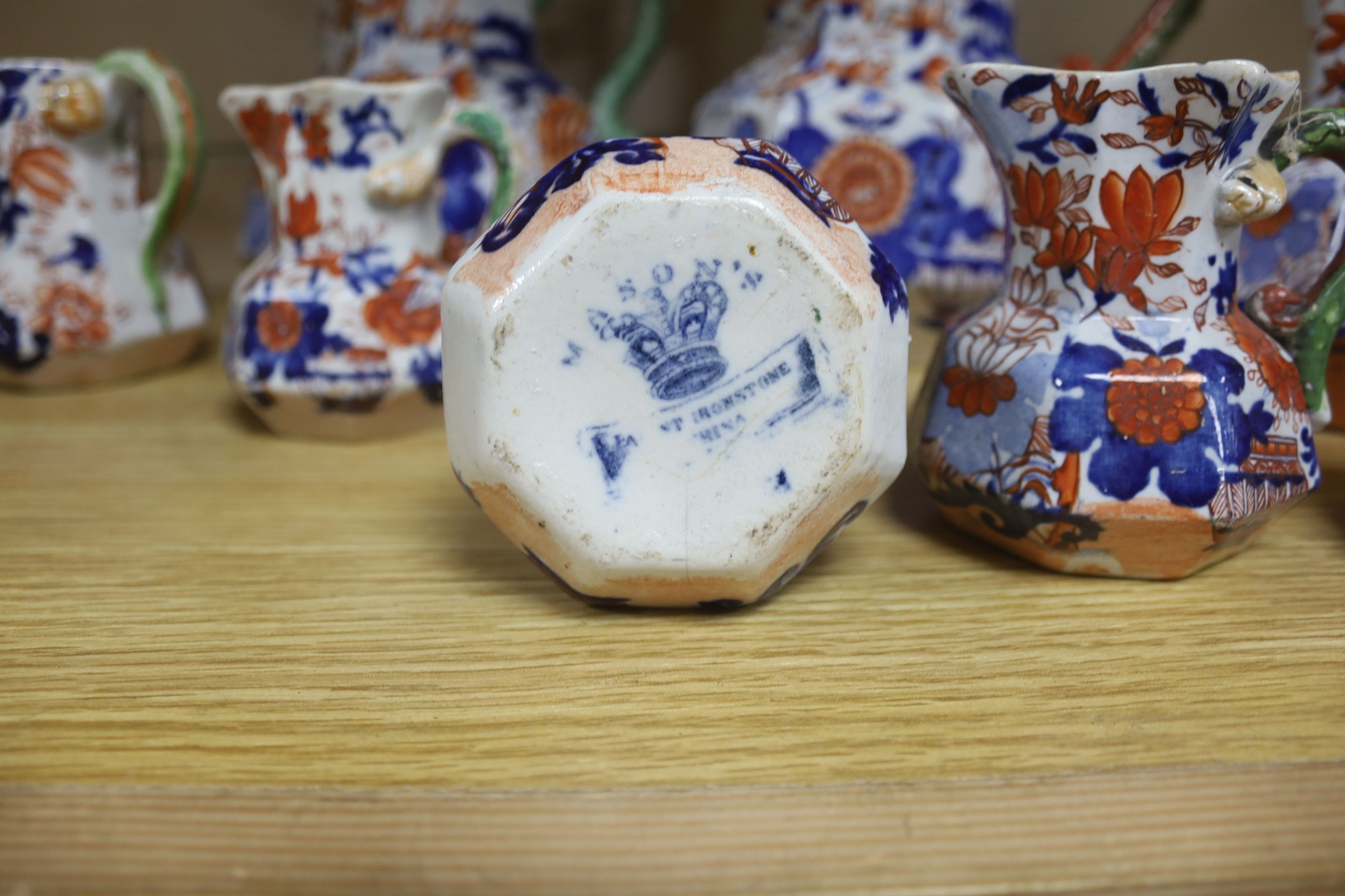 A graduated set of eight Mason's floral Imari pattern ironstone hydra jugs, c.1820-30, largest 19cm smallest 7cm and two other Mason’s ironstone jugs (10)
